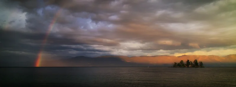 A rainbow and storm light over Flathead Lake